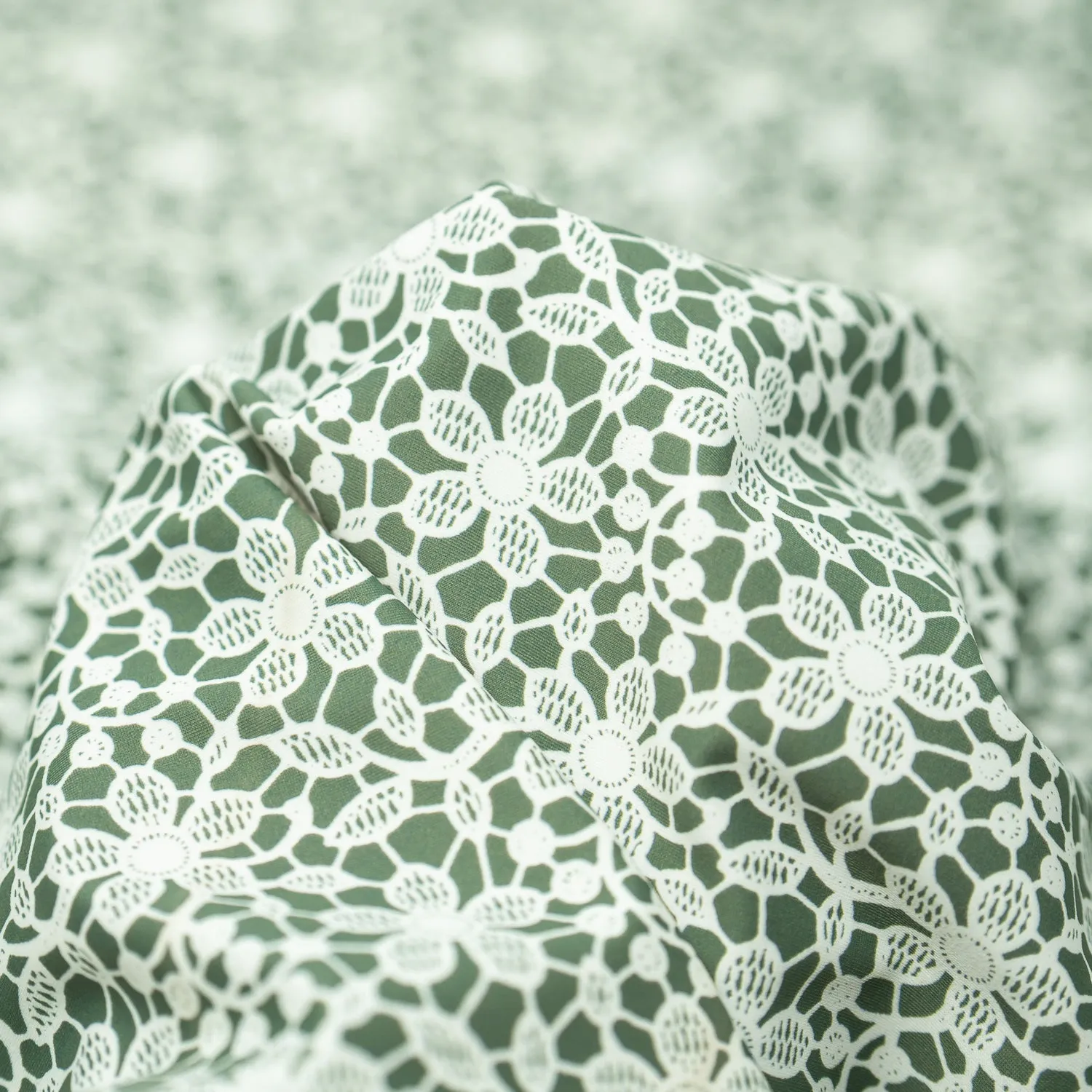 White Flower Lace Pattern on Sage Printed Spandex Fabric | Blue Moon Fabrics